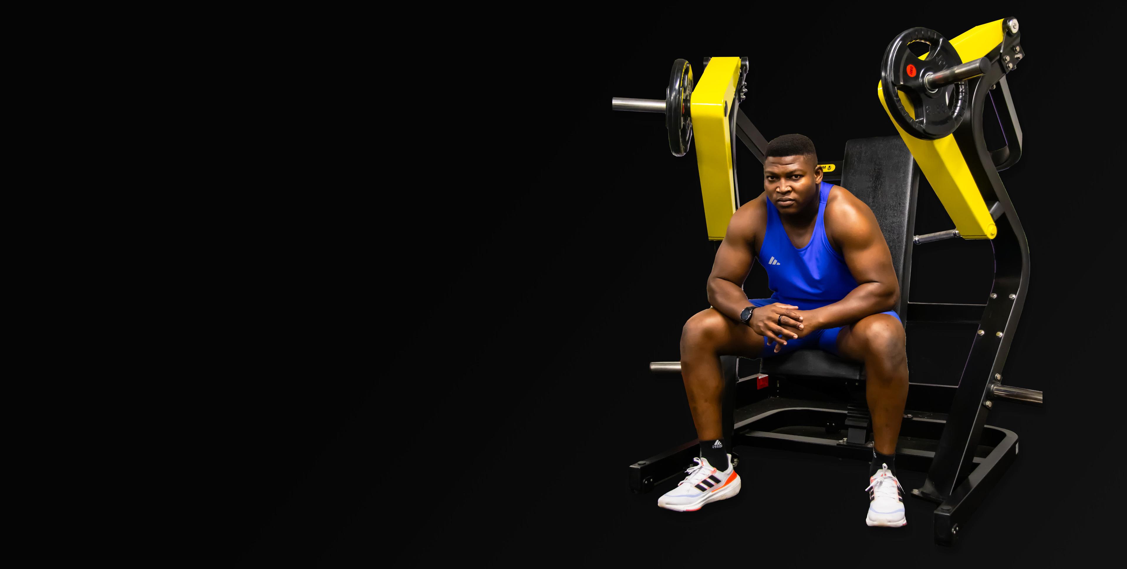 Man sitting on Gym Equipment in a gym studio. MX Series brand gym equipment